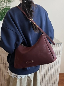 Retro burgundy frosted leather underarm bag with adjustable strap and metallic logo