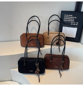 Detail view of suede leather handbags in four colors with minimalist shoulder straps