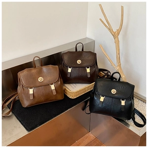 Detailed view of retro PU leather backpacks in black, coffee, and brown with gold hardware