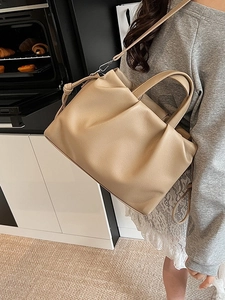 Chic beige ruched tote bag with soft leather texture for elegant daily commuting style