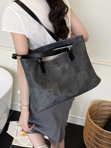 Large dark grey tote bag with leather handles and fashion lettering for commuting