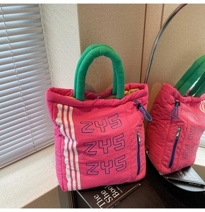 Detail of fuchsia quilted tote bag with green handles and ZYS letter print detail