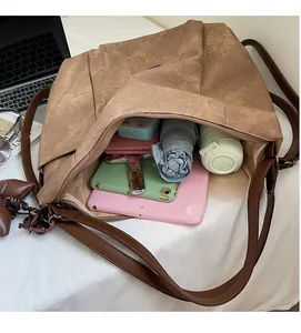 Interior view showing large capacity of the retro brown tote bag with various daily items