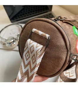 Primo piano della borsa a cilindro retrò con tracolla intrecciata e dettagli opachi