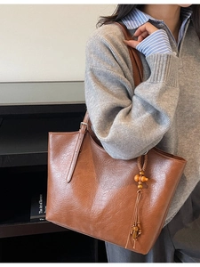 Vintage brown PU leather tote bag with tassel charm and adjustable strap for women