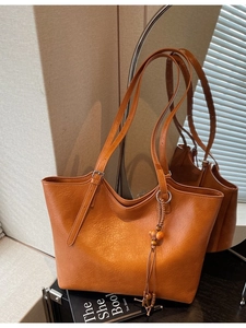 Retro caramel faux leather tote bag with wooden bead tassel and metal buckle straps