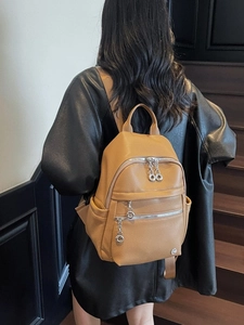 Premium caramel pebbled leather backpack with silver zippers and chain detail