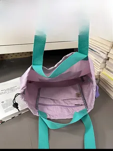 Macro shot of the lavender tote bag interior with a functional zipper pocket and drawstring