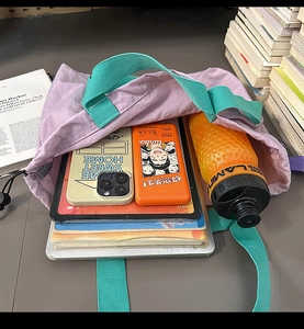 Spacious lavender drawstring tote bag showing internal storage for tablets and books