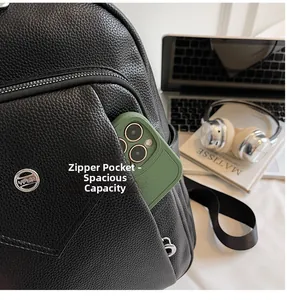 Close-up of pebble leather backpack front zipper pocket holding a large smartphone