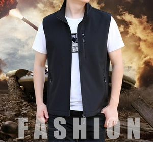 Close-up of men's black sleeveless vest featuring three functional zipper pockets