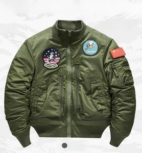Detailed view of army green bomber jacket with military embroidery patches and sleeve pocket