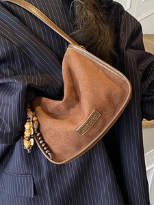 Brown frosted suede shoulder bag with retro bead tassel charm and textured crossbody design