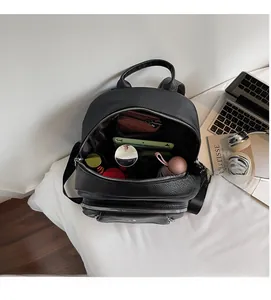 Internal view of the black textured backpack showing large capacity and multi-layer storage