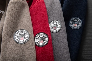 Detail of outdoor fleece jackets with Norway flag badge and thick textured warm fabric