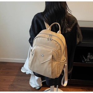 Detail view of stylish apricot leather backpack with high-quality metal zippers on back