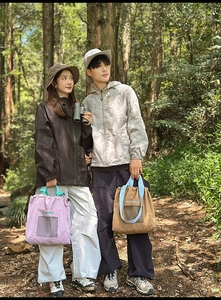 Outdoor scenario of large tote bags with mesh pockets and drawstring in forest setting