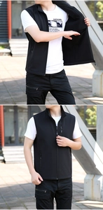 Detail of a black outdoor softshell vest showing the inner lining and zipped pockets