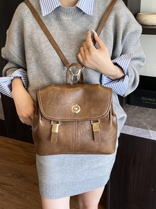 Vintage brown leather backpack for women with classic gold buckle and stylish flap design