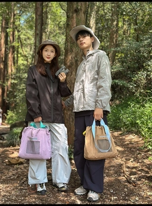 Close-up of drawstring tote bags in purple and khaki for outdoor leisure activities