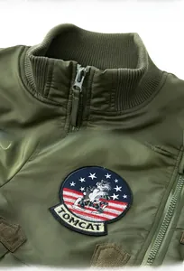 Detail of army green bomber jacket featuring ribbed collar and vintage Tomcat embroidery