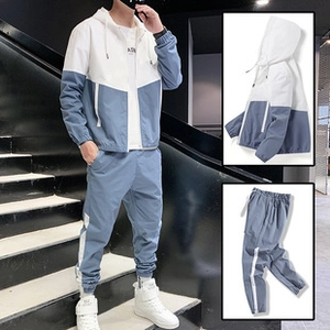 Detail of blue and white corduroy baseball jacket with drawstring hood and elastic cuffs
