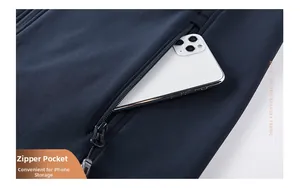 Detail of softshell vest showing deep zipper pocket holding a large smartphone