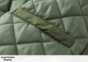 Detailed macro view of internal pocket on a green quilted bomber jacket with diamond stitching