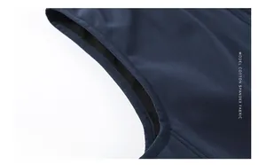 Detail of neat stitching on the armhole of a navy blue softshell vest in cotton spandex
