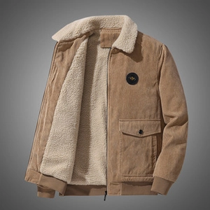 Detail of corduroy jacket with white fleece collar and leather patch on chest