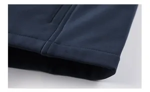 Detail of softshell vest hem showing precise double-needle stitching and spandex fabric