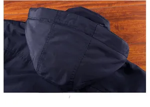 Detail show of hooded structure and fine stitching on dark blue winter jacket