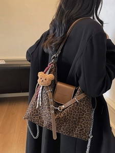 Large leopard print tote bag with brown leather trim and chain strap on shoulder