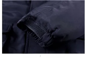 Detail view of adjustable velcro cuffs on deep blue winter jacket with fine stitching