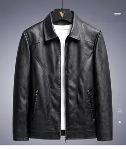 Detail of a black faux leather jacket featuring a classic collar and metal zipper pockets