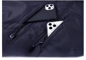 Macro view of blue men's winter jacket showing large zipper chest pockets for phones