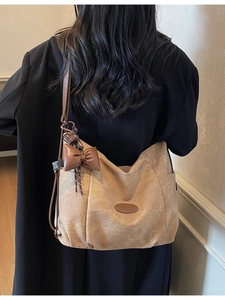 Retro khaki canvas tote bag with brown leather straps and vintage bow charm decoration