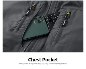 Detail view of large vertical zip pockets on grey outdoor vest holding two smartphones