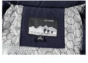 Detail of winter jacket collar featuring outdoor label and silver honeycomb heat lining