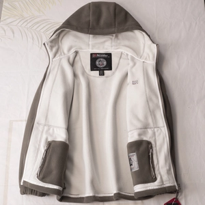 Close-up of Norway fleece jacket showing the warm white lining and secure zip pockets