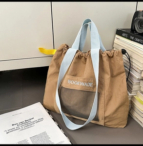 Brown drawstring nylon tote bag featuring light blue straps and black mesh front pocket