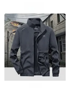Detail of dark grey outdoor jacket featuring mountain logo and adventure spirit print