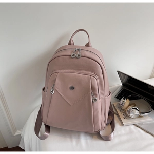 Pink faux leather backpack with laptop and headphones for a modern school scene