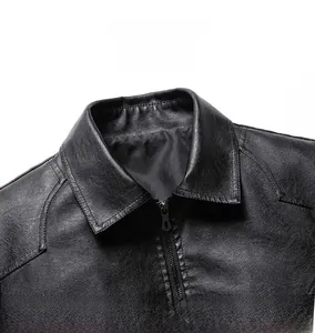 Close-up of black leather jacket showing classic lapel collar and metal zipper texture
