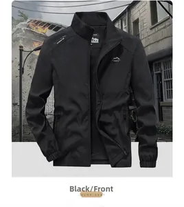 Detail of black outdoor jacket with stand collar and graphic prints on chest and shoulder