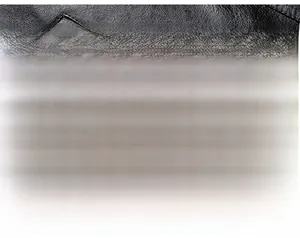 Detail of premium black leather jacket showing side zipper pocket with textured finish