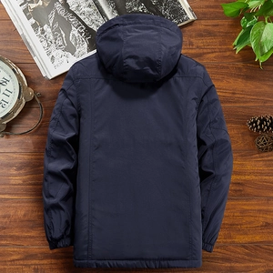 Men's navy blue hooded winter jacket with windproof cuffs on a rustic wooden background