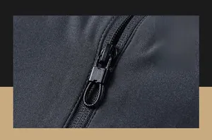 Detail of dark gray outdoor jacket showing durable matte zipper and woven pull cord
