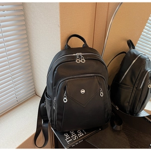 Detail showing high-quality black litchi grain leather and silver zipper hardware