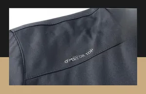 Detail of outdoor top shoulder with FOR ADVENTURE SPIRIT text and technical fabric